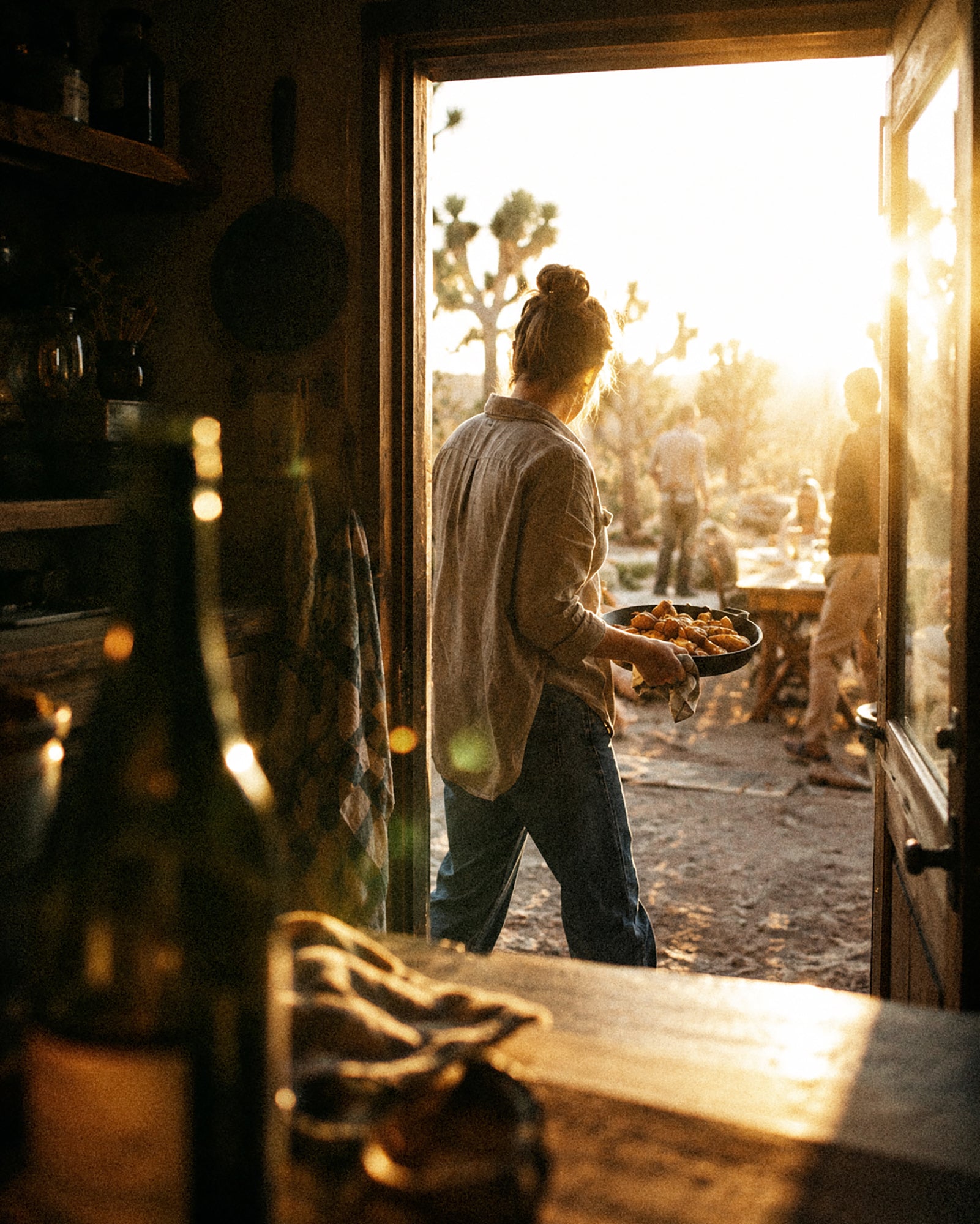 Carrying food through a doorway toward guests